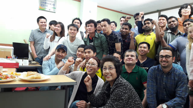 홍 센터장이 한 학기 수업을 마친 외국인 노동자들과 사진을 찍고 있다.