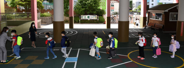 2차 등교 개학일인 27일 오전 창원시 성산구 대암초등학교에서 학생들이 발열체크를 위해 줄을 서 있다./성승건 기자/