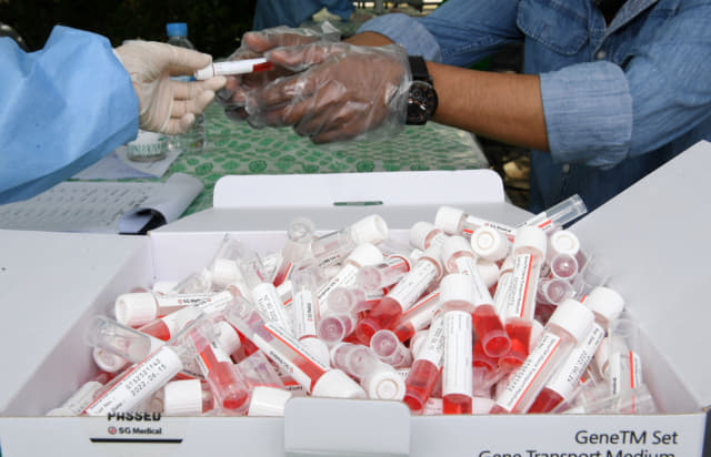의료진이 코로나19 검사 키트를 나눠주고 있다./경남신문 자료사진/