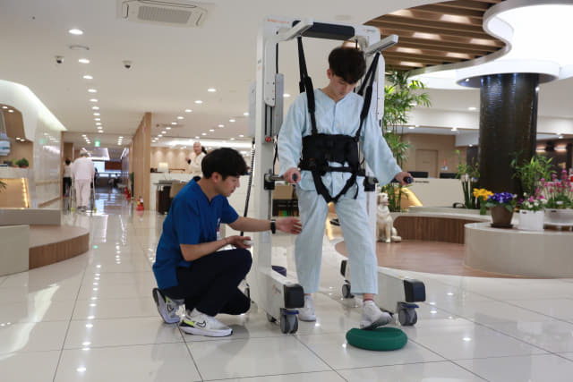 희연요양병원 환자가 의료진의 도움을 받아 로봇재활훈련을 하고 있다./희연요양병원/